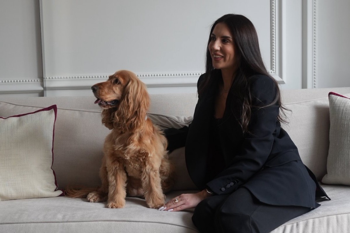 A woman sitting next to a dog