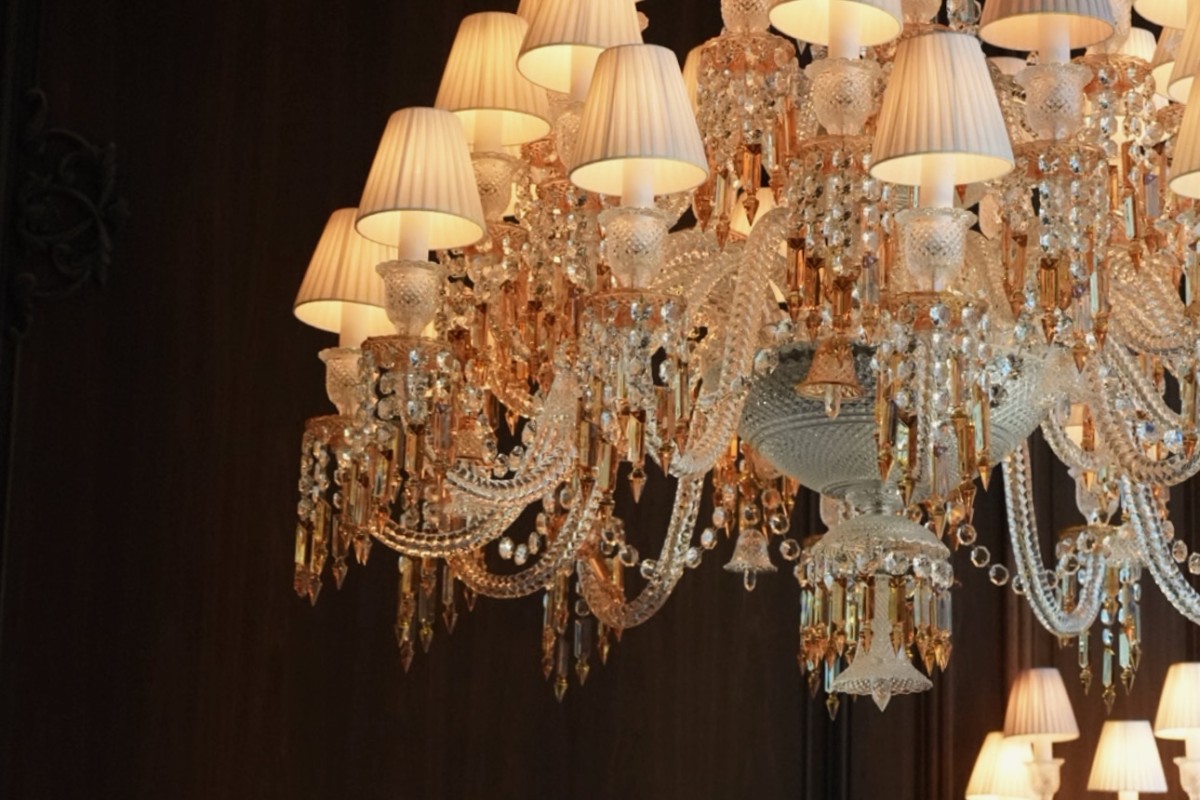 A large, ornate chandelier adorned with multiple lights and lamps, illuminating the surrounding space elegantly.