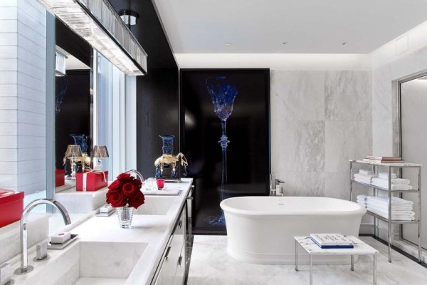 Bathroom of a Baccarat room suite featuring elegant decor and white marble walls
