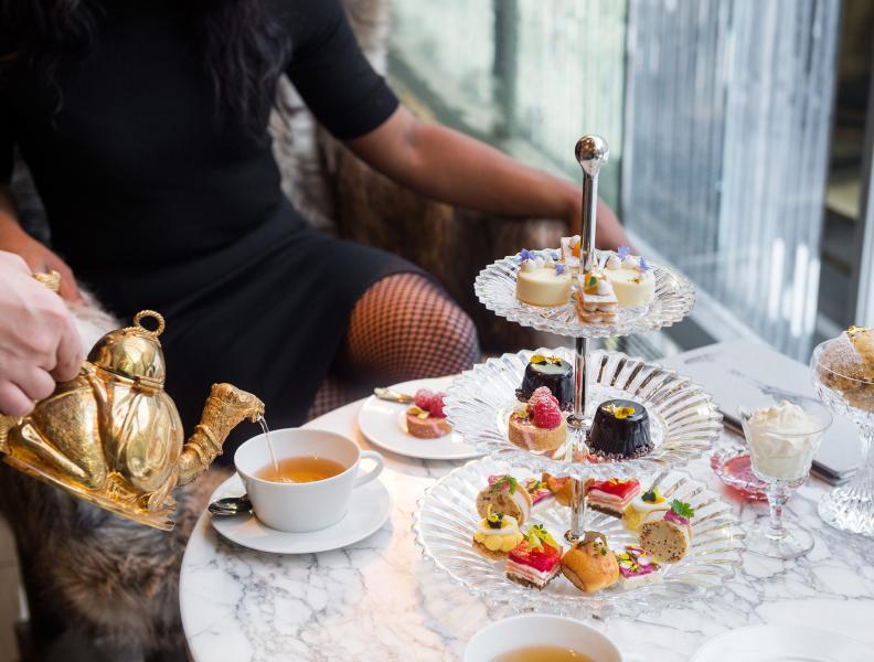 A guest being served afternoon tea at Baccarat hotel