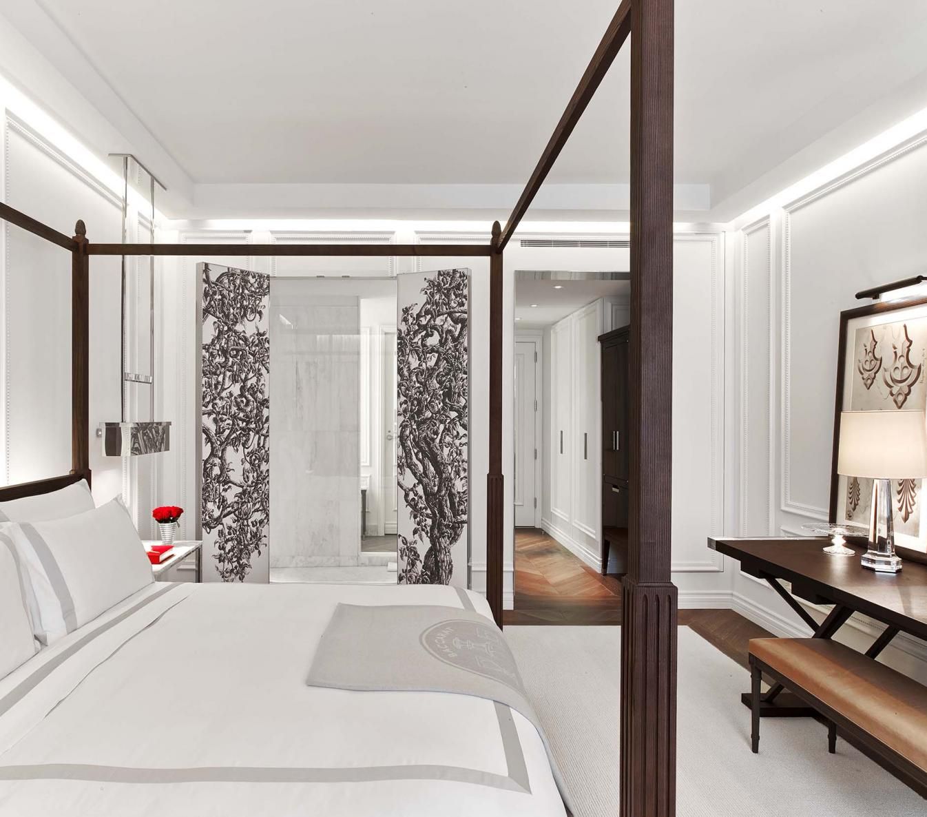 A white king sized bed in a room at Baccarat hotel