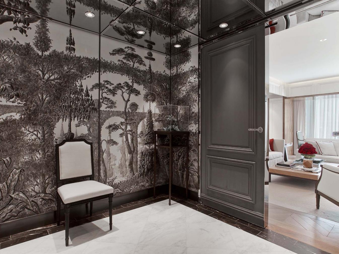 The corner of a room decorated with tasteful wallpaper shown in muted gray and white color tones