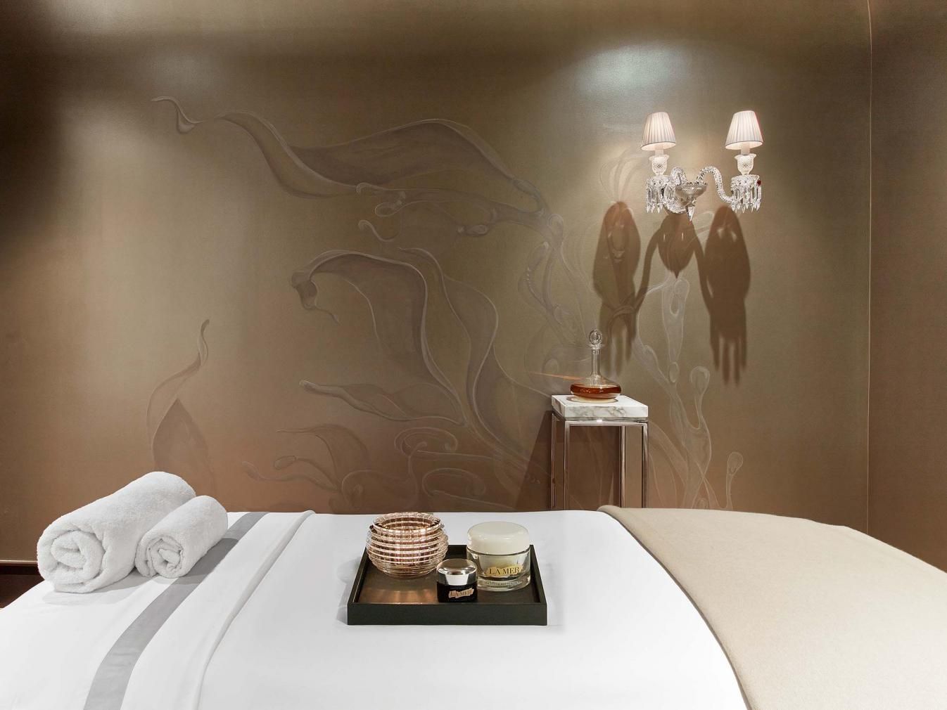 Spa bed with a tray of scented candles in the centre