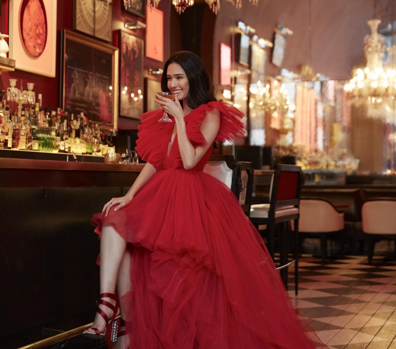 Woman sipping a cocktail at The Bar