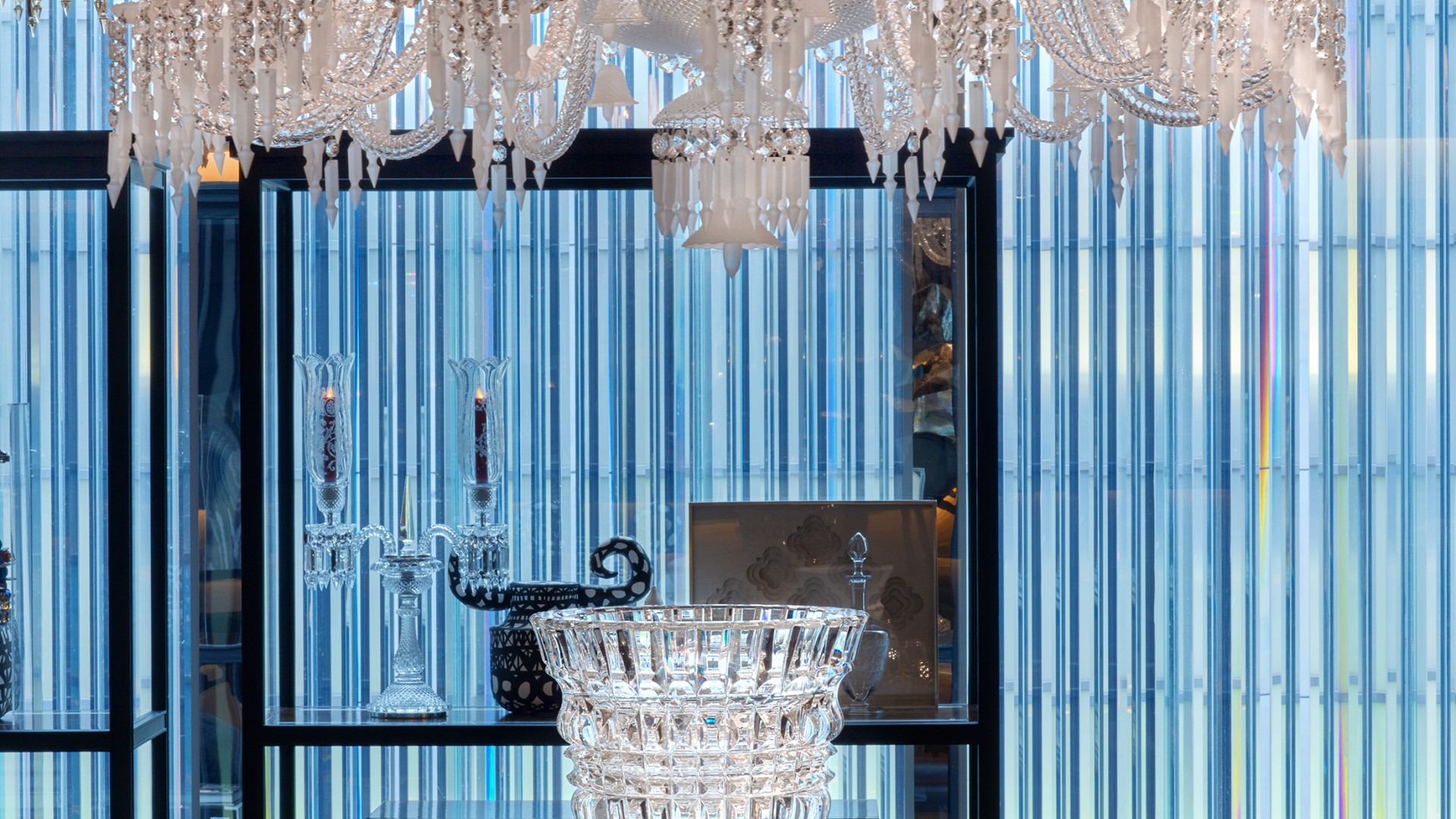 A crystal chandelier above a table at Baccarat Hotel NYC