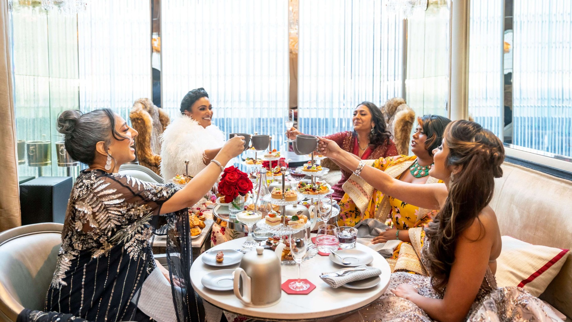 A group of people celebrating with food and drinks