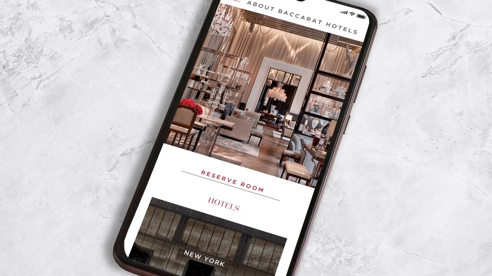 A smartphone shows a restaurant website featuring menu items and contact information.