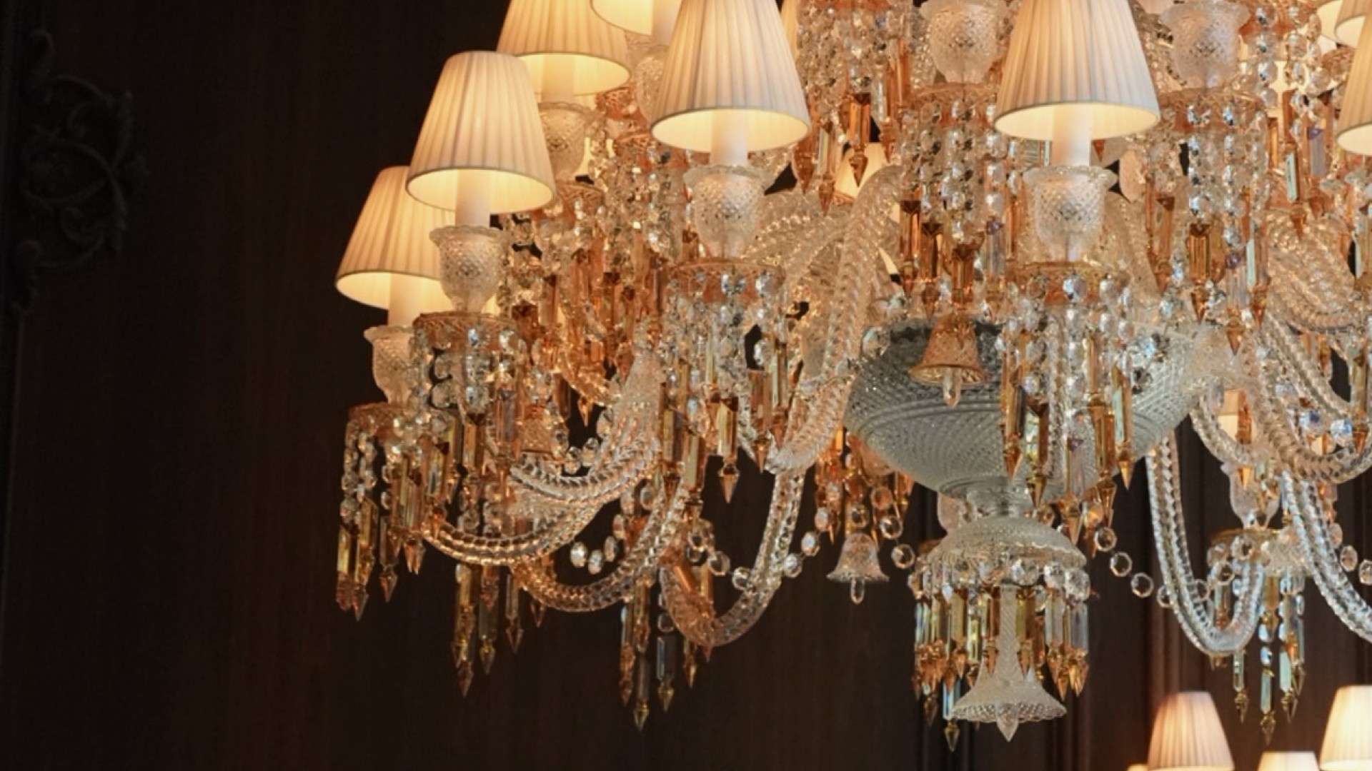 A large, ornate chandelier adorned with multiple lights and lamps, illuminating the surrounding space elegantly.