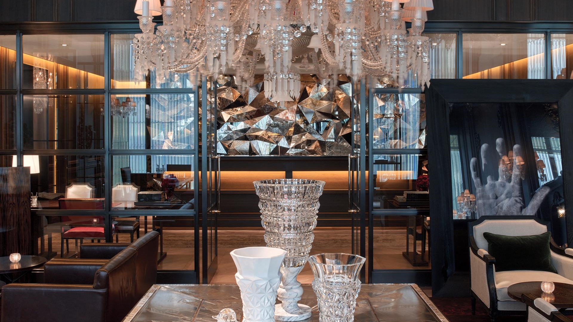 A stunning chandelier dominates the hotel lobby, adding a touch of luxury and brightness to the welcoming environment.