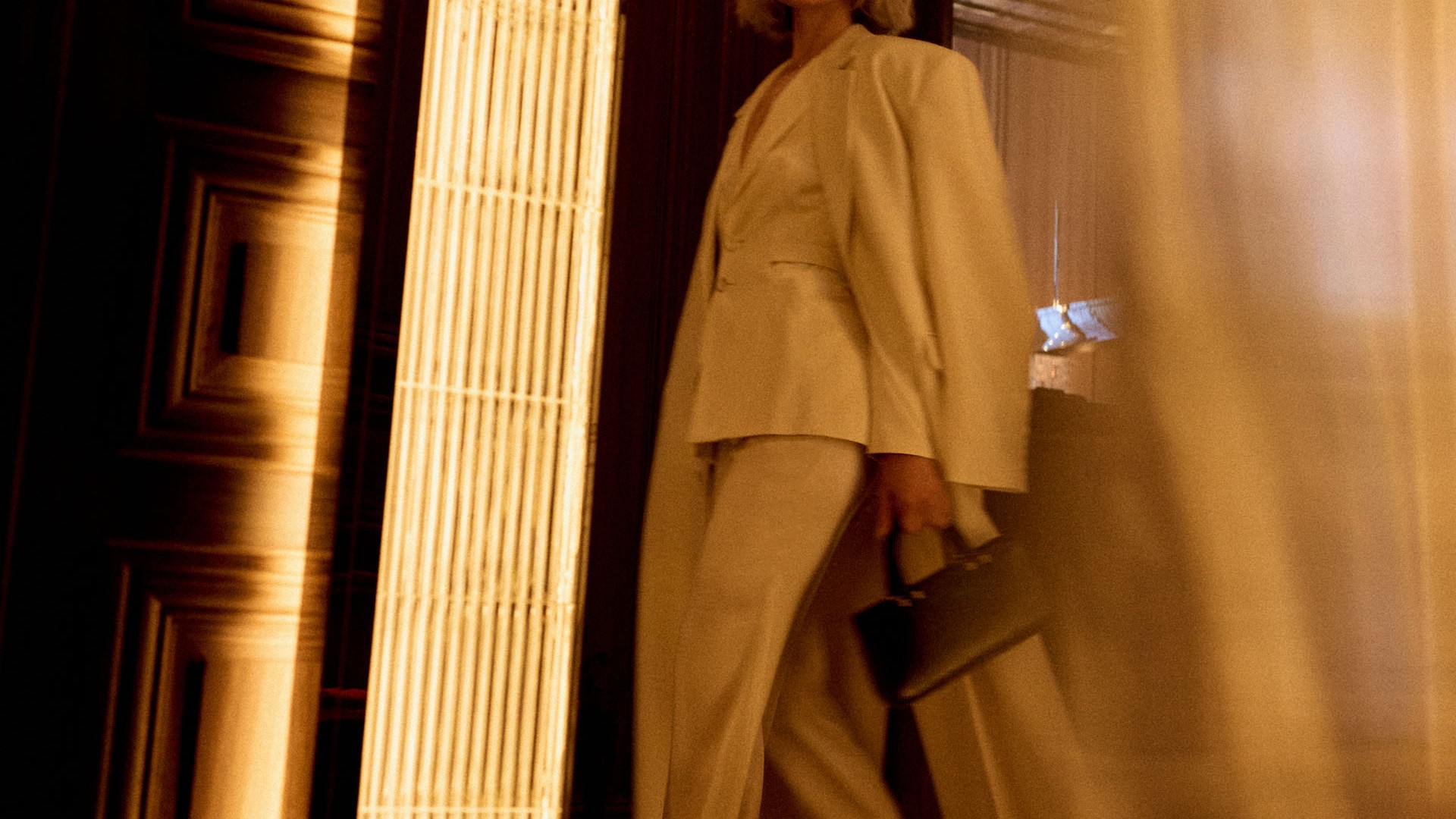 Women in a suit walking through a lobby at the hotel