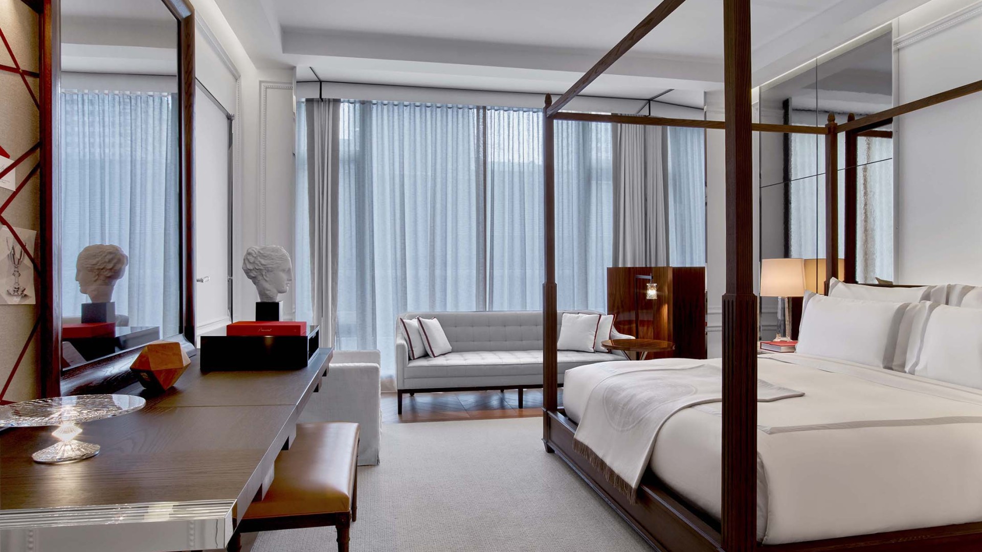 desk and king bed in a grand classic king room at Baccarat