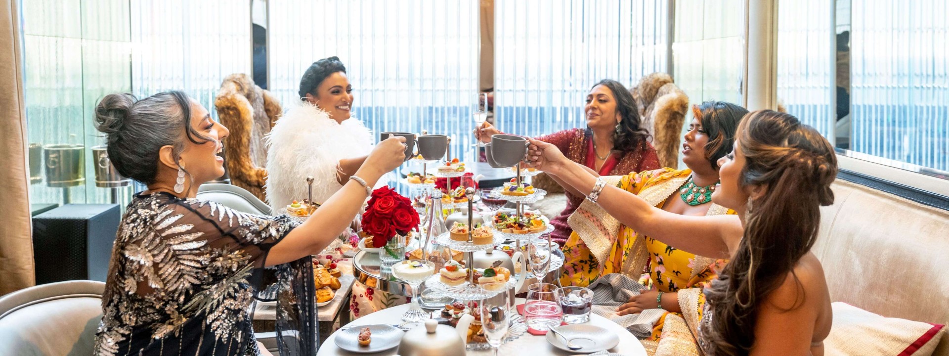 A group of people celebrating with food and drinks
