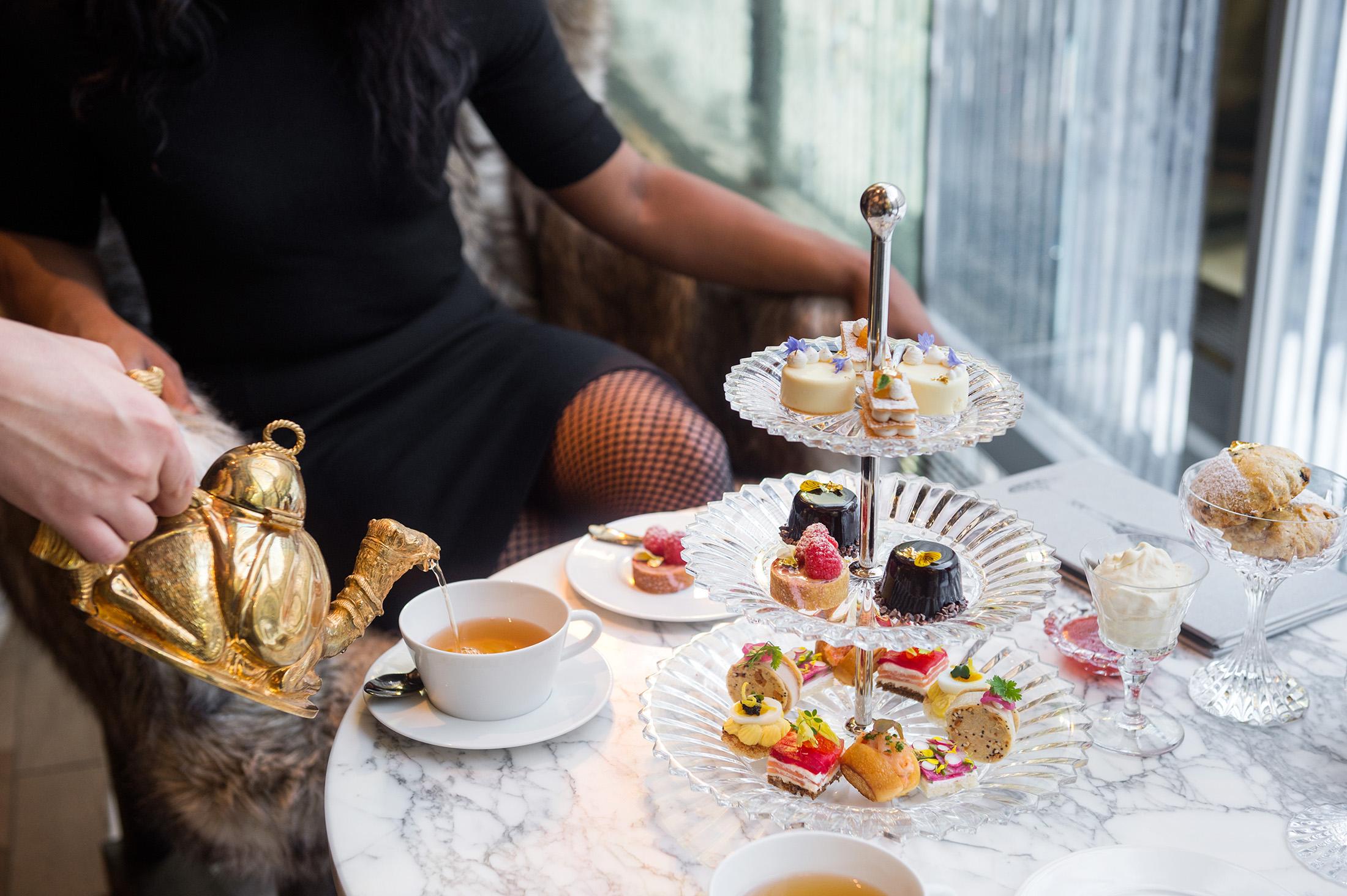 A guest being served afternoon tea at Baccarat hotel