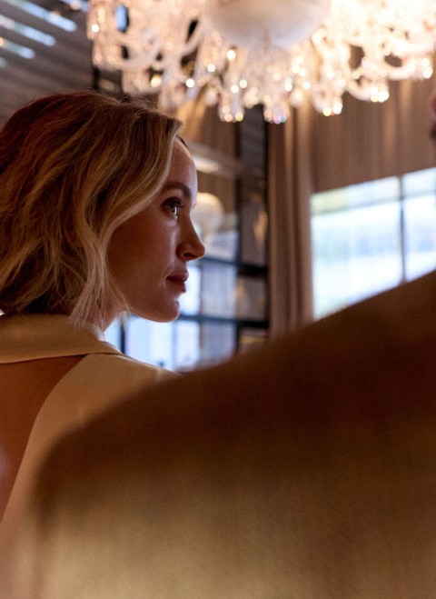 Chic woman with crystal chandelier in background