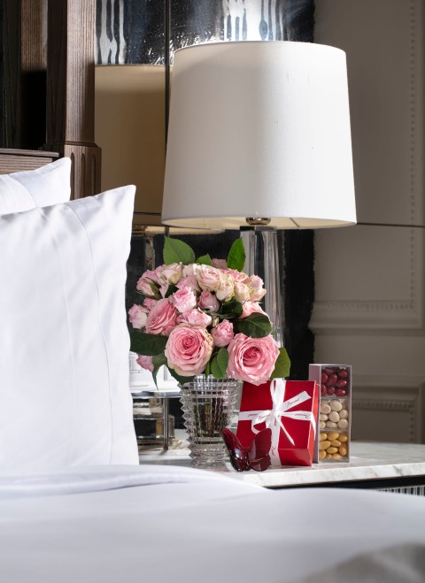 Flowers next to a table lamp