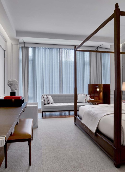 desk and king bed in a grand classic king room at Baccarat