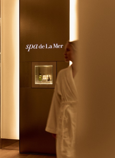 A woman at the spa walking in a robe 