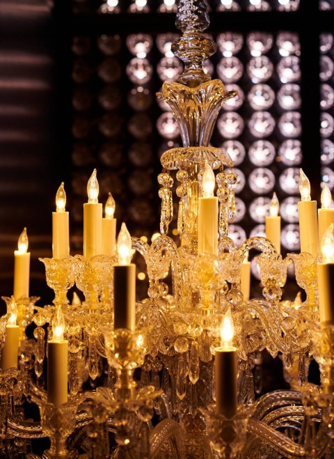 A decorative chandelier adorned with multiple candles, casting a warm and inviting glow in the surrounding space