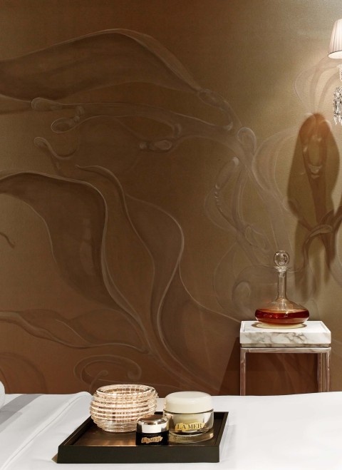 A simple bed adorned with a smooth white sheet, creating a clean and inviting appearance.