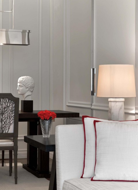 A white sofa adorned with vibrant red pillows, creating a stylish and inviting living space.