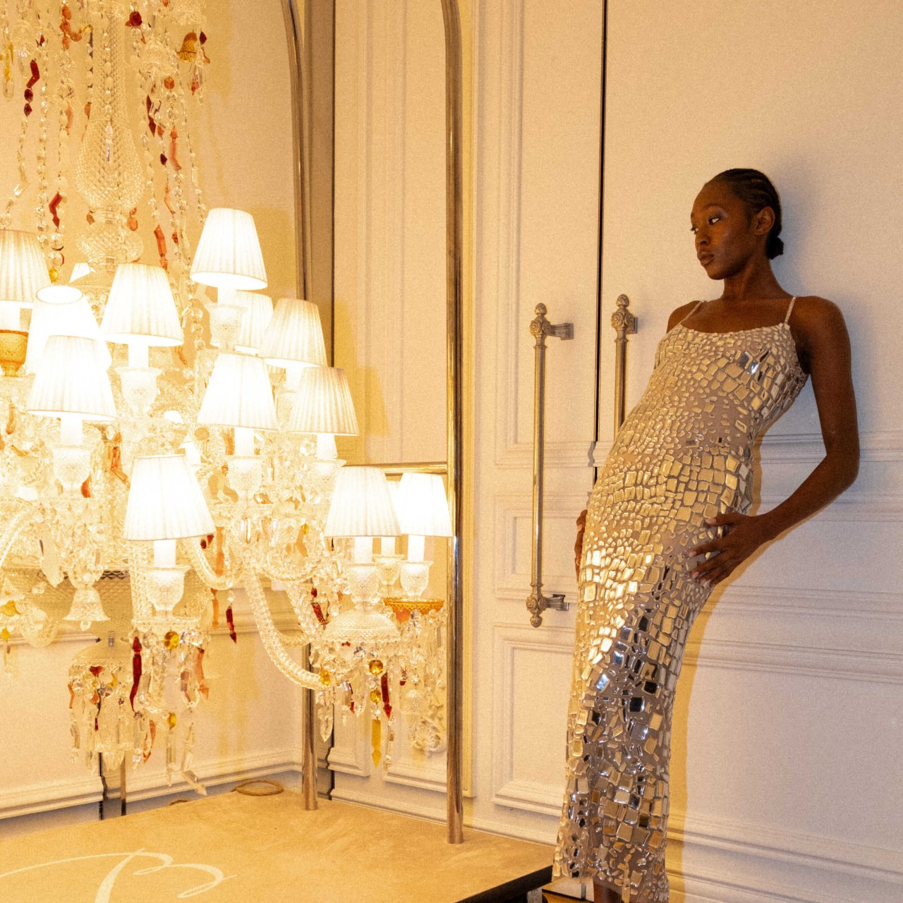 A woman posing next to a lamp