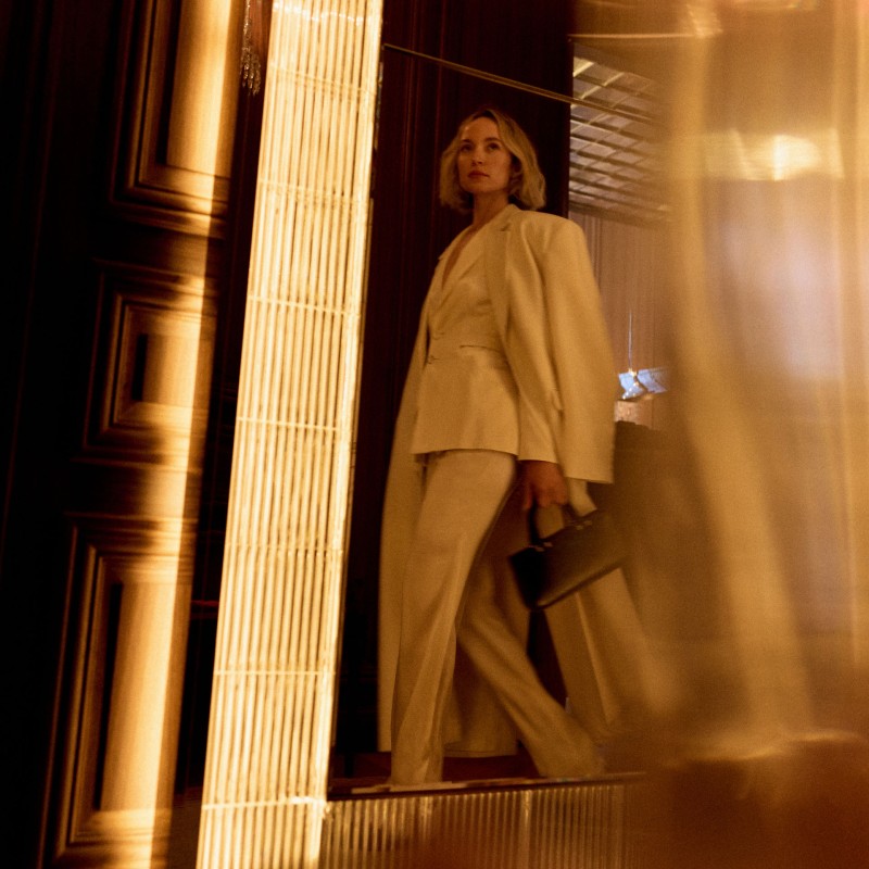 Women in a suit walking through a lobby at the hotel