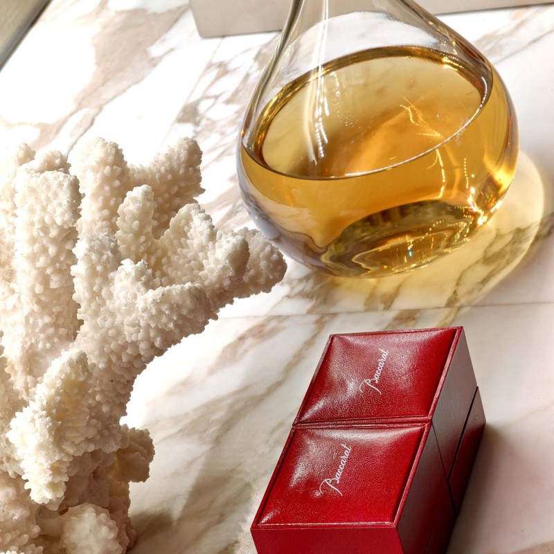 A red box placed on a polished marble countertop, showcasing a contrast between the vibrant color and the elegant surface