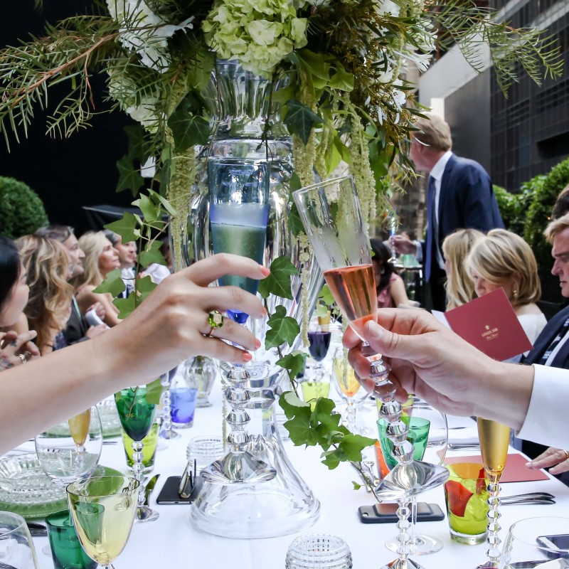 A man and woman raise their champagne glasses in a toast for wedding