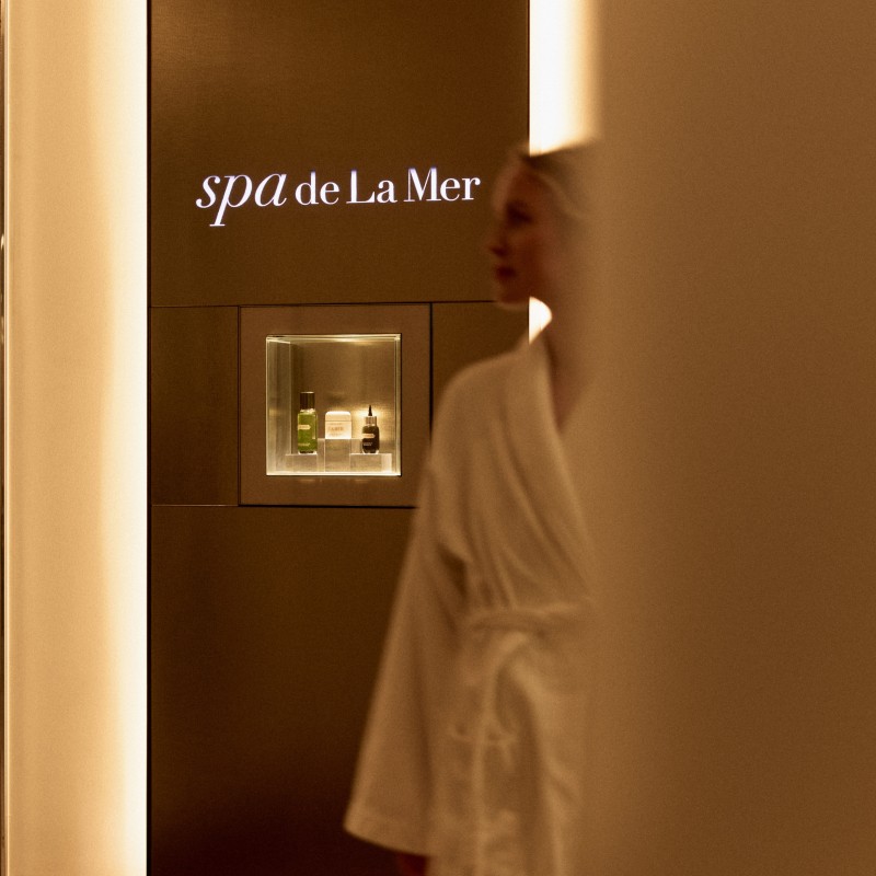 A woman at the spa walking in a robe 