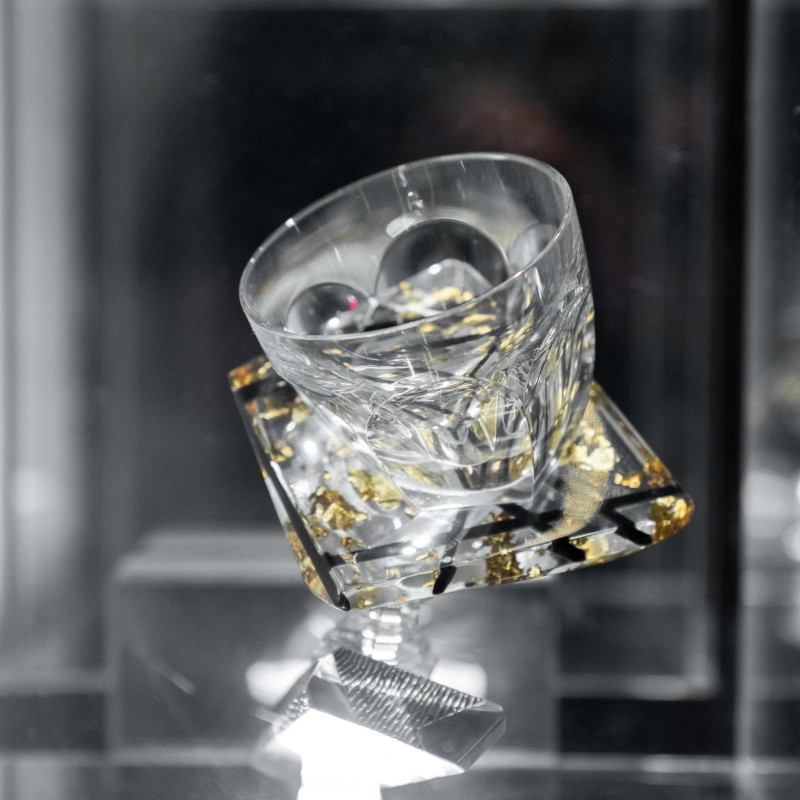A glass adorned with a stylish gold and silver pattern, highlighting its artistic and luxurious appeal
