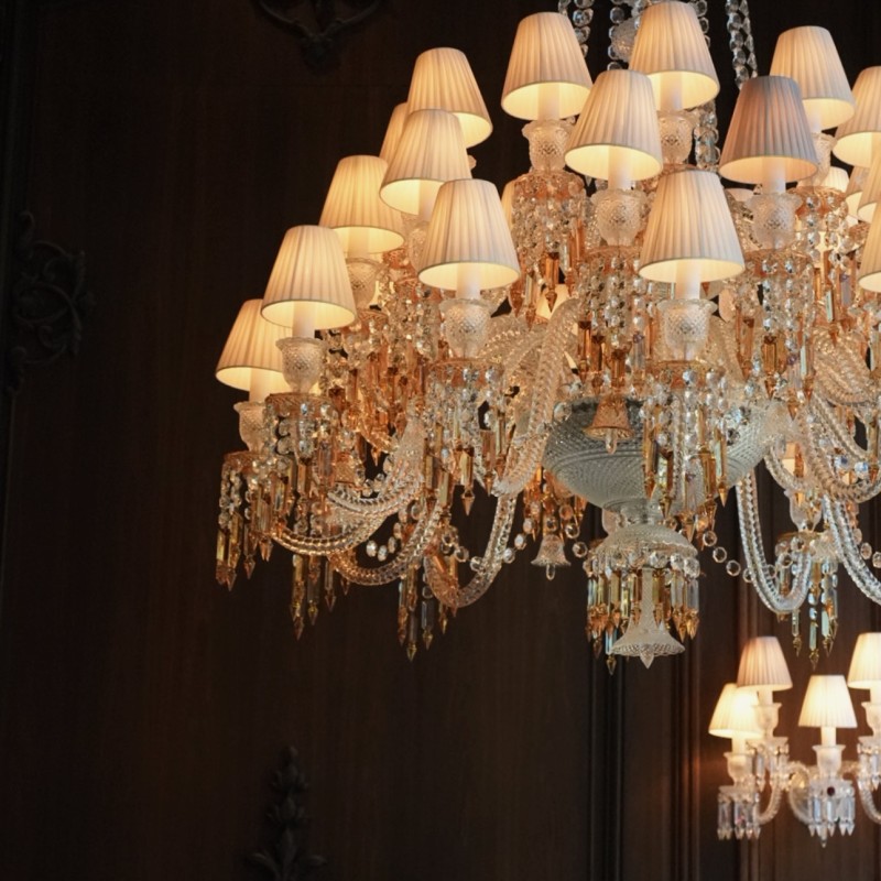 A large, ornate chandelier adorned with multiple lights and lamps, illuminating the surrounding space elegantly.