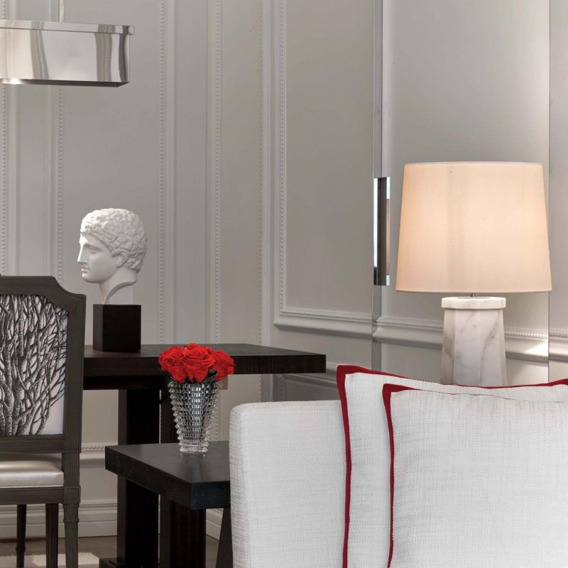 A white sofa adorned with vibrant red pillows, creating a stylish and inviting living space.