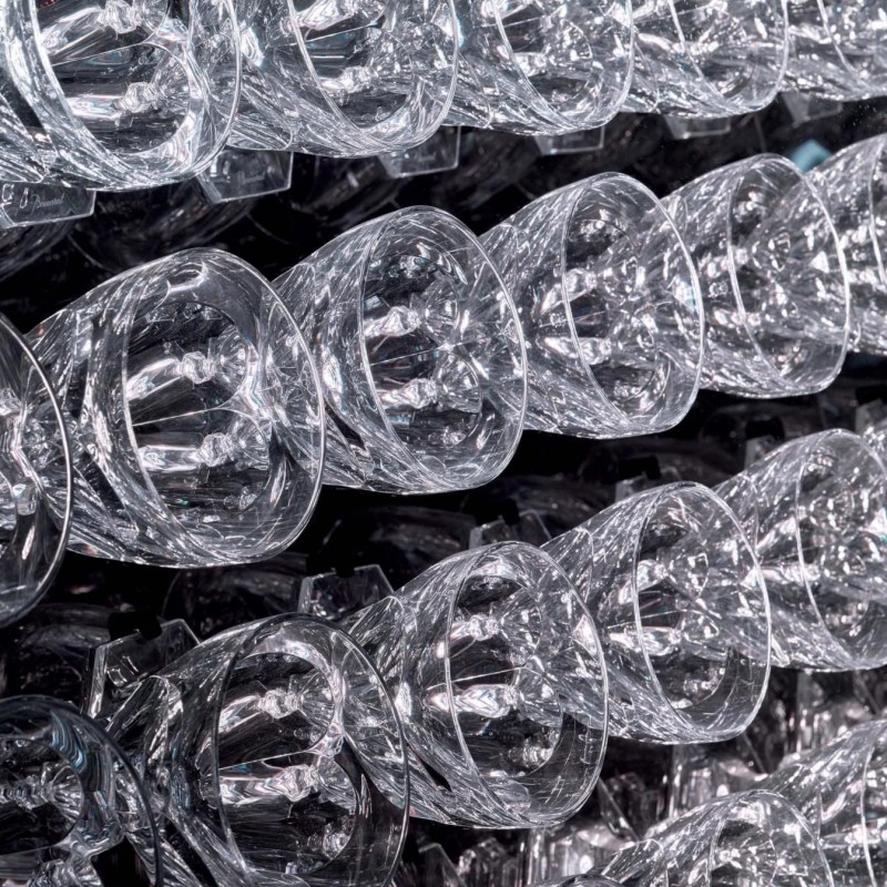 Several empty wine glasses lined up on a table, highlighting their clear glass and delicate design.