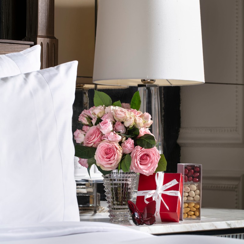 Flowers next to a table lamp